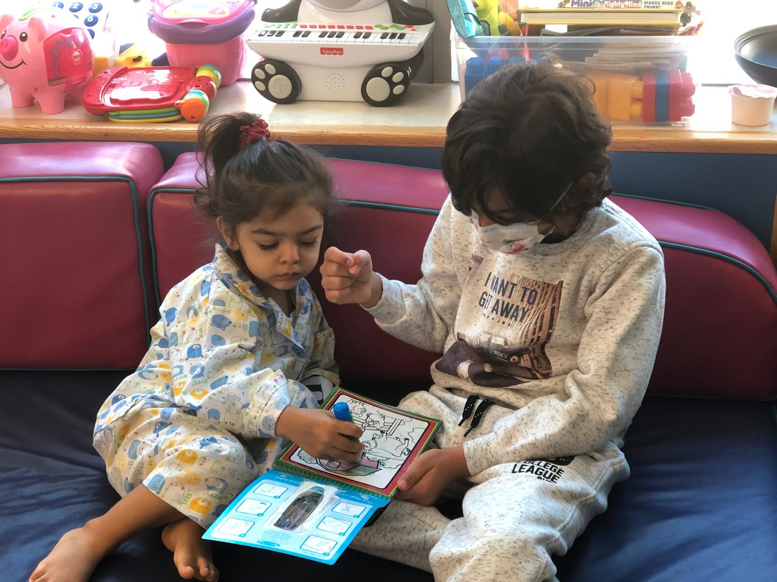 Two children playing with a Joy Box activity in the hospital
